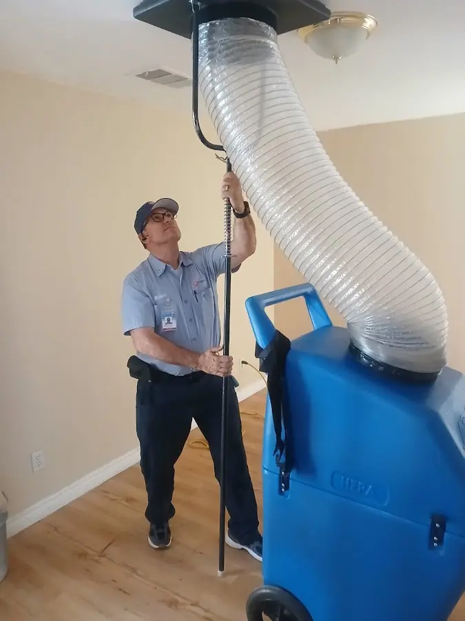 Furnace Tune-Up technician using HEPA equipment in Artesia